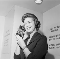 Donna Johnson listens to a solar-cell-powered transistor radio at a Hobby Industry Association of America show in Chicago. A flick of the switch changes the radio operation from solar power to pen light batteries. February 5, 1963. February 5, 1963 Chicago, Illinois, USA